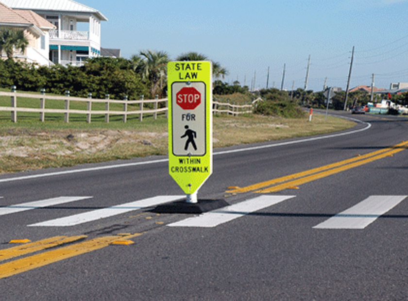 pedestrian crosswalk sign in roadway